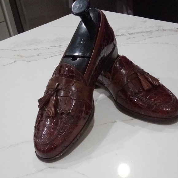 Brown loafers slip-on with tassel decoration and embossed leather